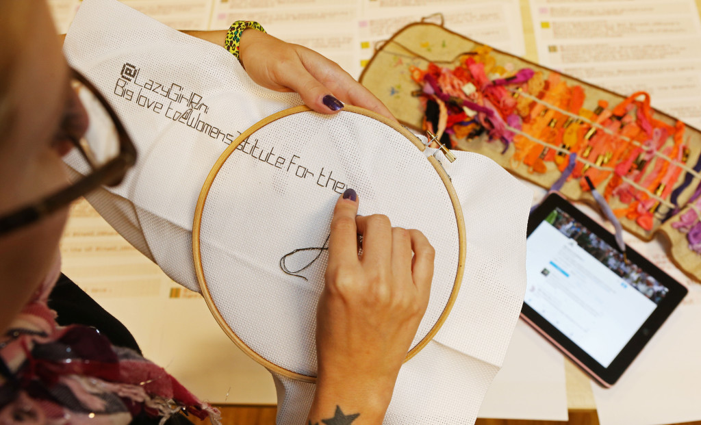 Mandatory Credit: Photo by Joe Pepler/REX Shutterstock (5086417e) A member of the WI stitches a twitter message onto canvas WI Twitter live-stitching, Women's Institute Headquarters, London, Britain - 16 Sep 2015 The National Federation of Women's Institutes is celebrating its centenary in 2015. As part of the celebrations, and to bridge the gap between the traditional reputation of the WI and the modern digital age, the Institute held a 'tWItterstitch' live event.  During the event, a group of WI members live-stitch anniversary wishes that are received via Twitter by both manually cross-stitching and machine stitching the messages. The tweets are then auto-printed onto a sewing pattern as they are received and handed to one of the stitching team to be committed to canvas. Each individual stitched tweet is added to a large wall hanging, which will be put on display at the NFWI headquarters to provide a lasting legacy of the online buzz around the centenary.