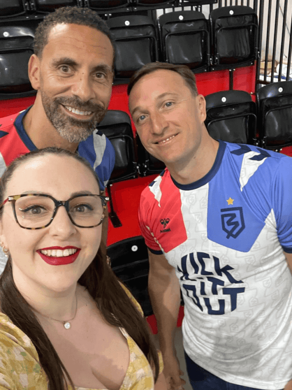 Umpf member, Danni smiles to the camera, with ex-footballers and legends, Rio Ferdinand and Mark Noblre at the launch of Ballerz in Bluewater, Kent