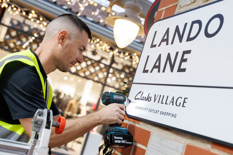 Lando-Lane-street-renaming-PR-stunt-for-Clarks-Village-Shopping-Outlet-sign-drill